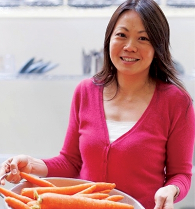 Woman holding dish of carrots