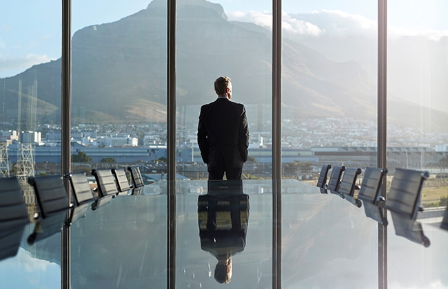 Man in conference room looking at from from the window