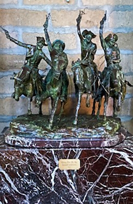 Bronze statue of cowboys