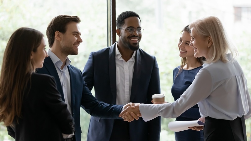 Group of executives shaking hands