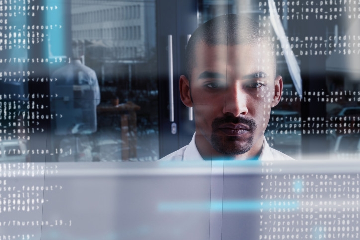 Man reviewing code on a glass screen